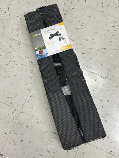 New, in original mesh bag packaging, a Lavika car top carrier for kayaks. Includes foam pads and str...