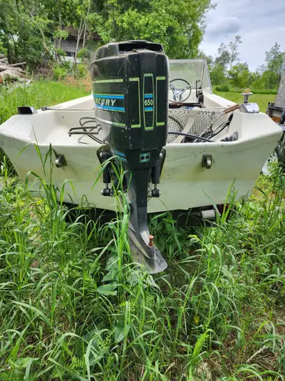 14 foot boat trailer and 65 mercury that runs. Must take boat