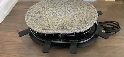 Trudeau raclette grill featuring a granite stone top and eight individual pans. Rarely used, like ne...