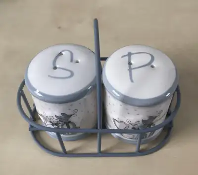 This adorable set features the cutest little cats on the front and back of the shakers. The total le...