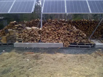 Slab wood left over from milling large spruce, pine, and fir logs, cut into pieces for burning. It's...