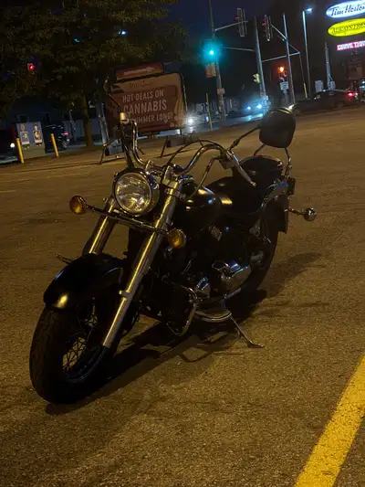 Cruising in style with this 2004 Yamaha v-star, a sleek black motorcycle perfect for both city commu...