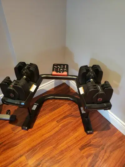 For sale is a pair of Bowflex Adjustable Dumbbells from 5lbs to 60lbs, also comes with the Media Sta...