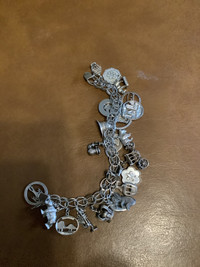 Silver bracelet and 20 silver charms on it