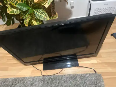 This is a used Sharp LCD TV with a 42-inch screen, perfect for a bedroom or small living room. It's...