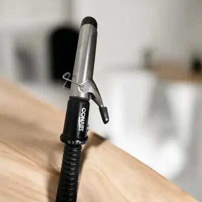 Create beautiful curls with this Conair curling iron, featuring a 1-inch barrel for versatile stylin...