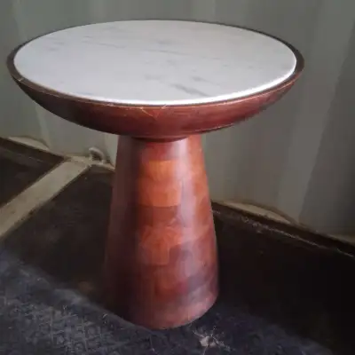 This distinctive end table features a round marble top paired with a unique wooden base, making it a...