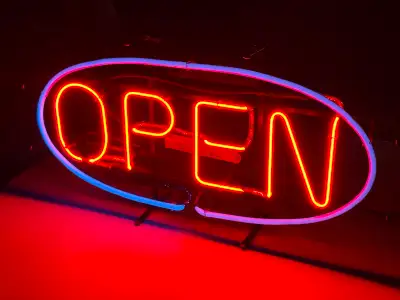 For sale is an AUTHENTIC vintage NEON sign (“OPEN”), featuring red lettering and blue oval border. N...