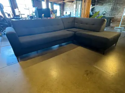 This modern, dark grey L-shaped sectional sofa offers both style and comfort for your living space....
