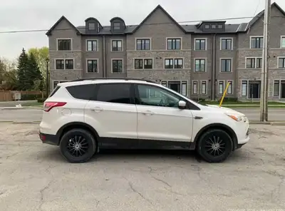 I am selling a 2014 Ford Escape. This SUV is used and has some rust and a dent on the rear side pane...