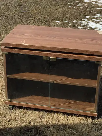 TV stand. Swivel top. Glass doors. Two interior shelves. 16” x 27” x 22” high. $30.00. Pick up near...