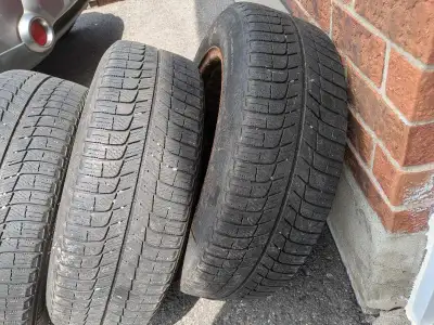 Selling a set of four used winter tires, size 215/60R17, mounted on steel rims. These tires have see...