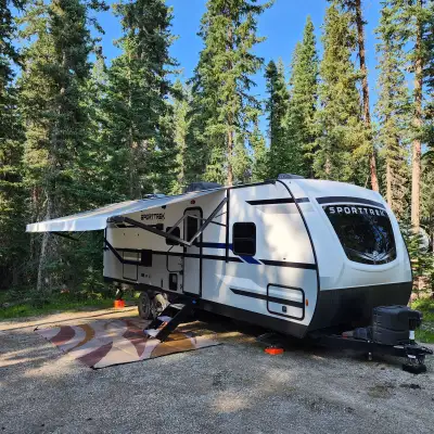 Includes: One slide; queen bed; fold-out sofa; dinette with 4 chairs; outdoor cook station w fridge;...