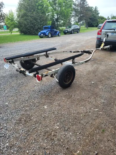 BOAT TRAILER WITH TWO SPEED WINCH WITH STEEL CABLE , ALSO HAS LIGHTS AND SAFTY CHAINS READY TO HAUL...