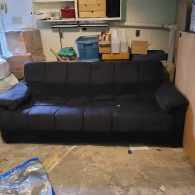 Free black couch that folds down flat into a bed. Micro fiber type fabric. Has been sitting in the g...