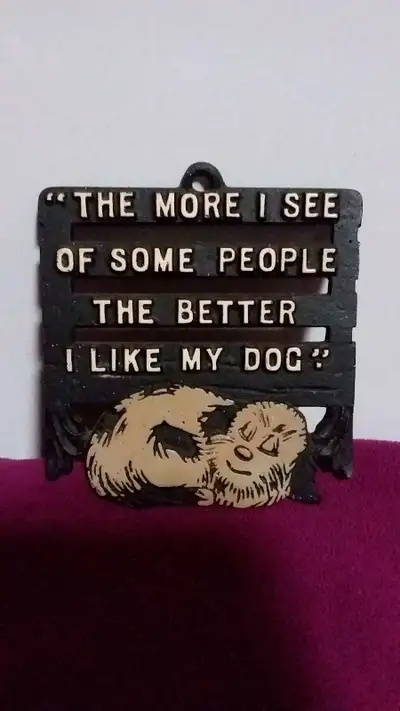 Dog Trivet or wall hanger with saying. Black metal with white print and tanish dog. Length just unde...