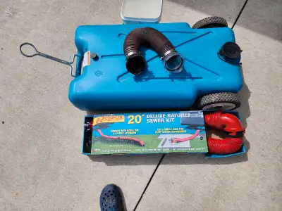 Large tow behind tank with hitch, 20 ft. never used sewage hose, short hose for loading sewage tank.