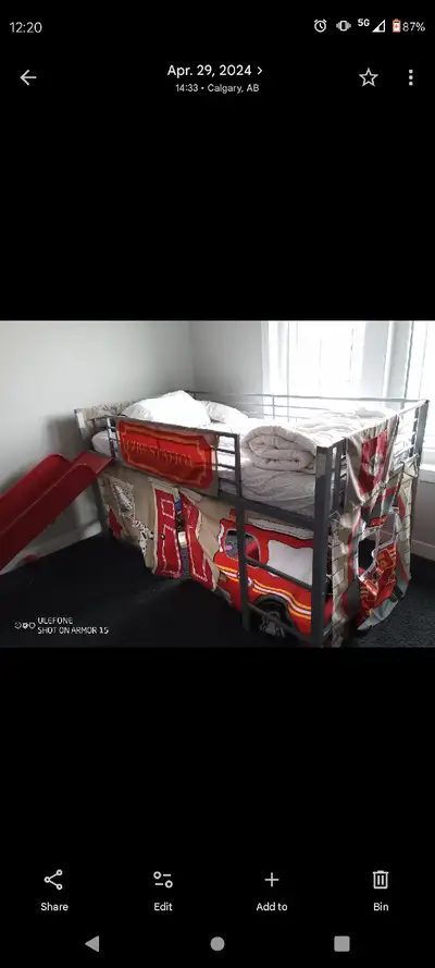 This is a charming, used bunk bed with a fun fire truck theme, perfect for kids' rooms and sleepover...