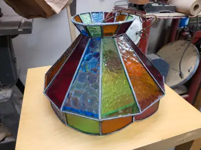 Multicoloured stained glass shade. Metal frame. Chain and ceiling mount included. Sold as is. Listin...