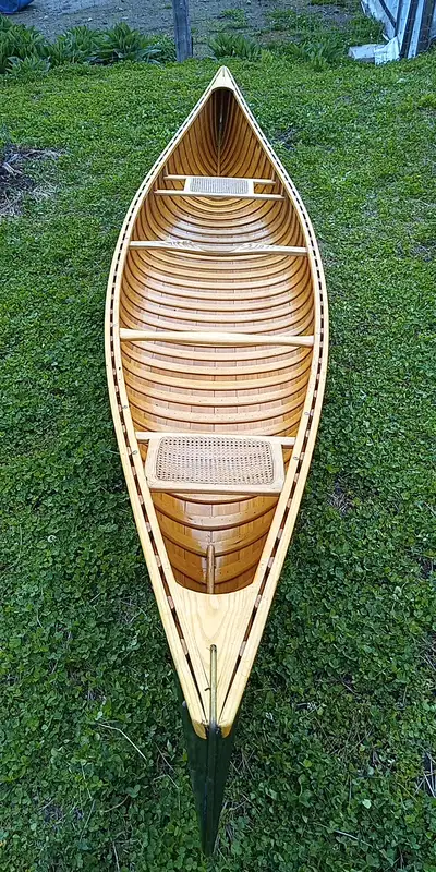 Beautiful wood and canvas canoe. Original form. Wooden yoke.