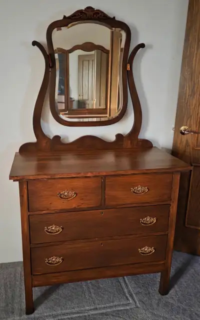 This antique vanity/dresser is a charming addition to any room. It features a beautiful mirror and f...