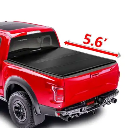 Upgrade your truck with this high-quality, matte black hard tri-fold tonneau cover, specifically des...