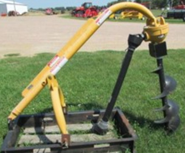 One three point hitch post hole auger made by shaver Farming