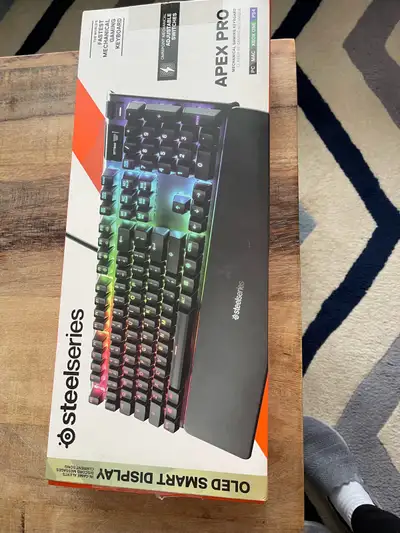 Selling a SteelSeries Apex Pro mechanical gaming keyboard in used-like new condition, known for its...