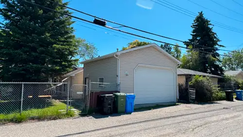 Detached double garage with high ceilings Built-in loft for upper-level storage Workbench, shelving,...