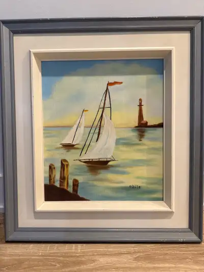 Je vends une charmante peinture à l'huile encadrée représentant des voiliers, apportant une touche m...