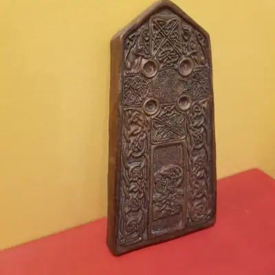 This Celtic cross tablet , Art- is a bronze coloured piece. The back of the tablet provides a descri...