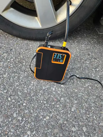 The image shows a Woowind DP3 Smart Tire Inflator, an electric air pump for inflating tires and othe...