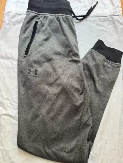 These are a pair of used Under Armour track pants, perfect for workouts or lounging. They're in good...