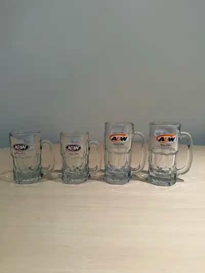 These four authentic A&W glass mugs, featuring the classic brand logo and 'Since 1956' branding, are...