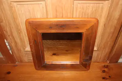 Vintage mirror in a wooden frame. The mirror shows some wear and marks. The backing is an old piece...