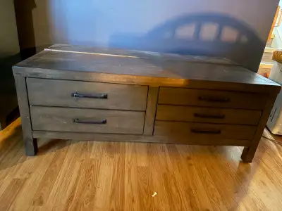 Solid wood coffee table for sale asking $200 obo. 5 drawers and storage compartment in back. 50 inch...