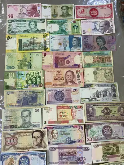 Here is a collection of world bank notes. These notes are in used condition, with varying degrees of...
