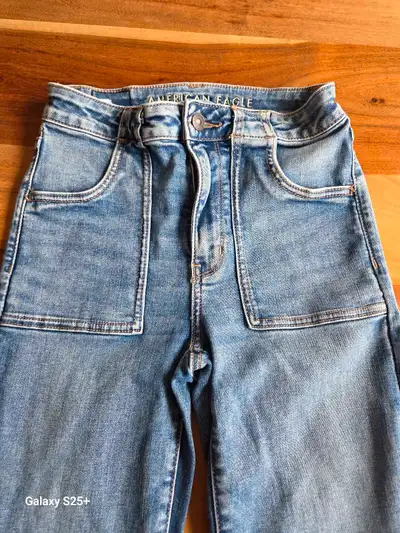 These jeans are size 2 and feature a trendy flare leg and a flattering high waist. Never worn. Key F...