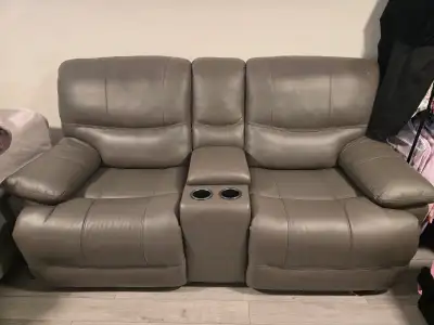 Comfortable and modern genuine leather power reclining loveseat in grey. Features smooth power recli...