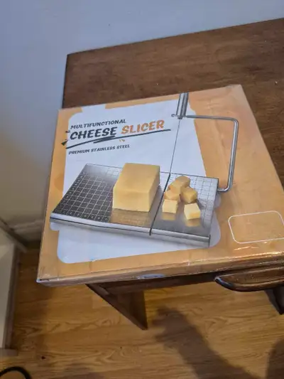I'm selling a new multifunctional cheese slicer made of premium stainless steel, perfect for slicing...