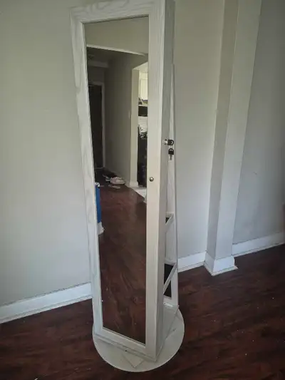 This rotating jewelry armoire mirror is in great condition and offers a perfect blend of style and o...