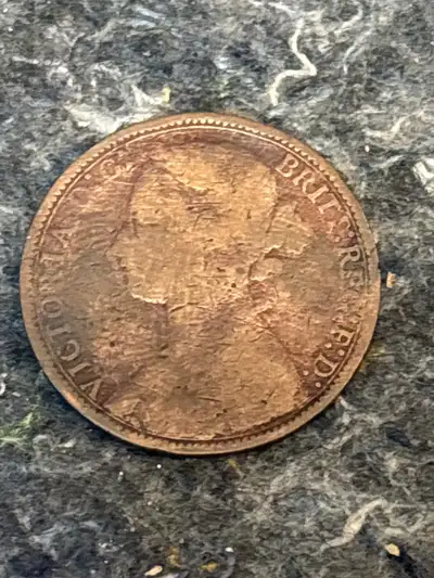 This is an 1877 Queen Victoria One Penny coin. As you can see from the photos, it's a used coin with...