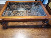 Wrought iron, glass, solid wood coffee table.
