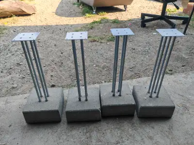 Selling a set of four robust metal stands with heavy concrete bases. These stands are perfect for va...