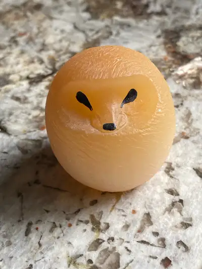 Small decorative hedgehog sculpture made out of citrine.