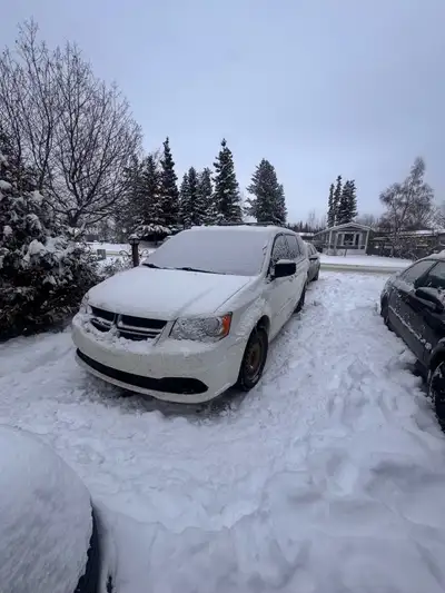 Very clean dodge caravan. Has studded winters on rims and summers on rims, remote start, and backup...