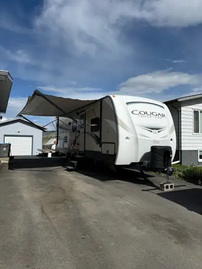 Selling our 2018 Cougar 25 BHS Has double bunks and King walk around bed. Electric awning, stabilize...