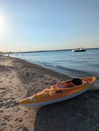 Get ready to explore the open water with this vibrant, used Pelican Venture Kayak, perfect for solo...