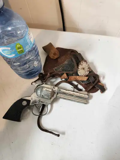 Howdy partners! This here is a used Nichols Colt 45 toy gun, perfect for your little buckaroo's adve...