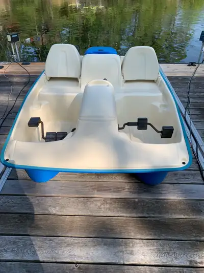 Pedal Boat. Off white on top, blue on bottom. Good condition. Seats 5. 4 cup holders. Storage or dri...
